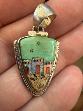 925 Navajo-style pendant features a detailed pueblo village scene